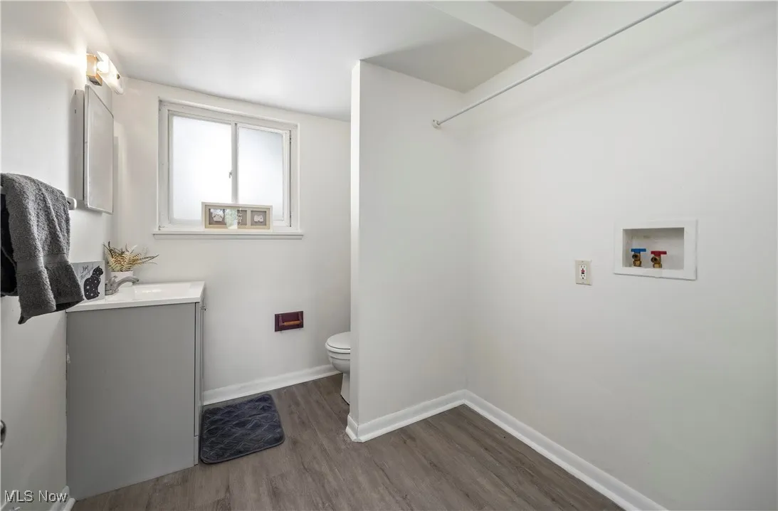 lower level Bathroom with wood finished floors and vanity