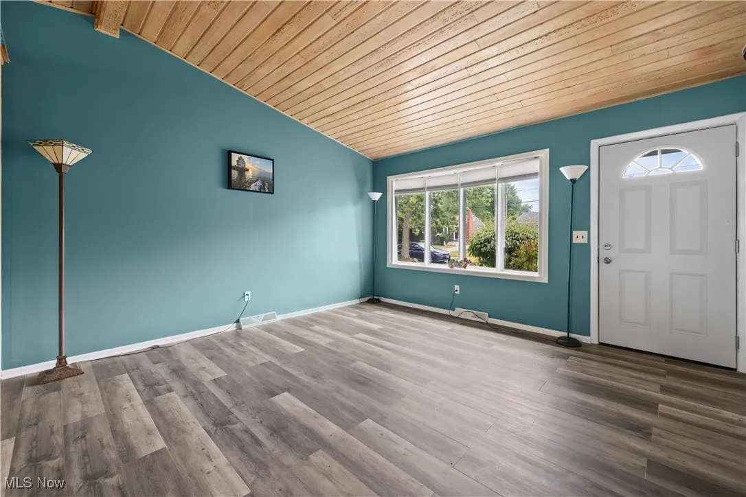 Living rm featuring wood ceiling, vaulted ceiling, and wood finished floors