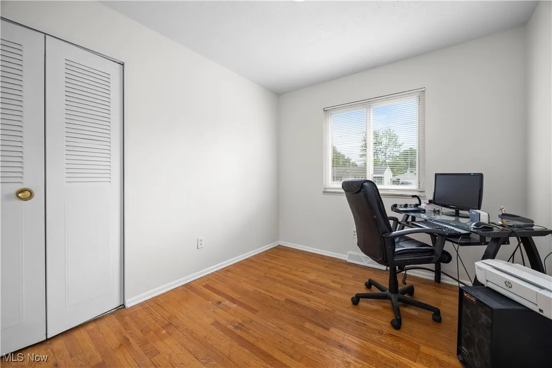bedroom featuring wood finished floors and baseboards