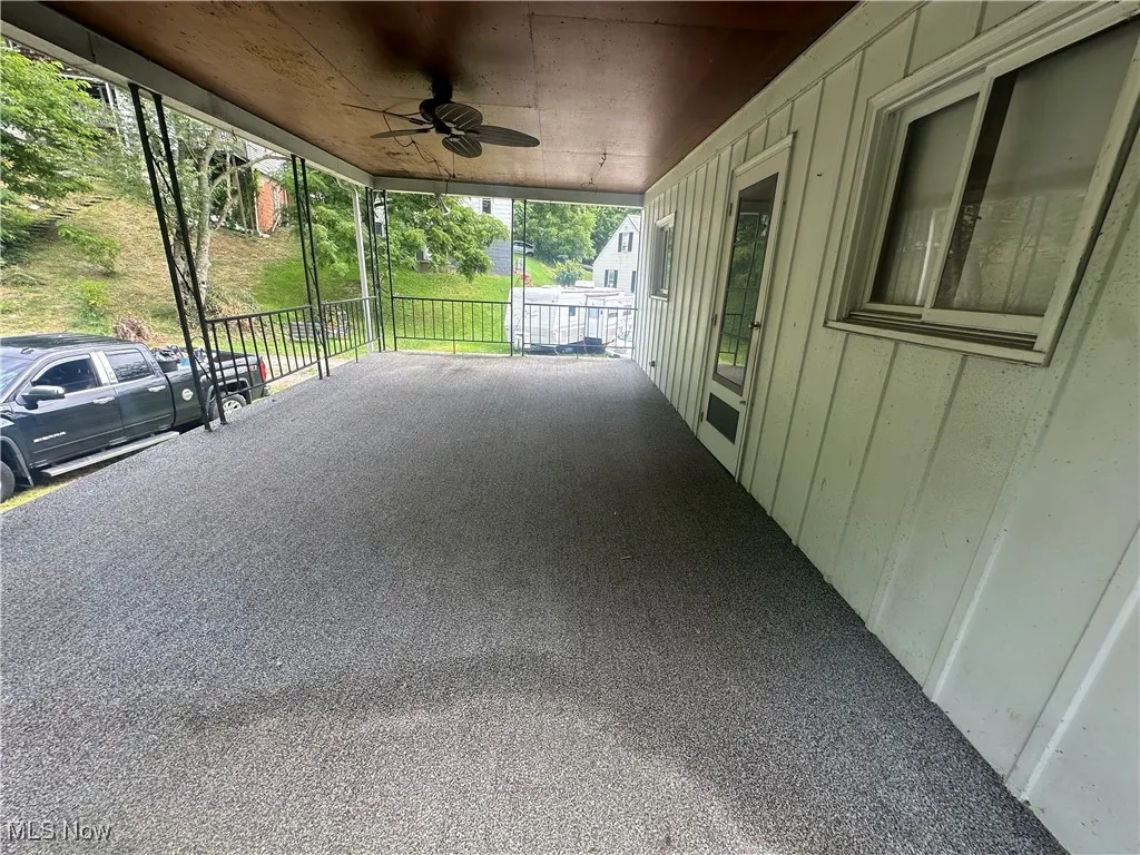 View of patio featuring an attached carport and ceiling fan