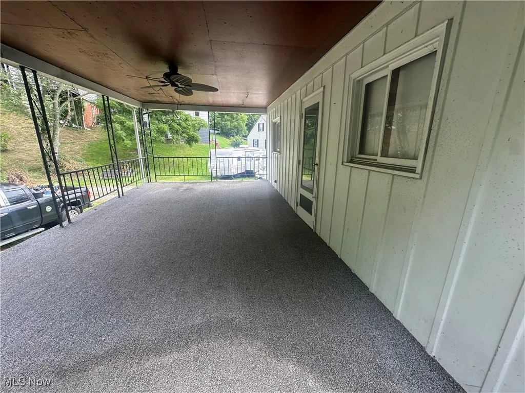 View of patio / terrace with a carport and a ceiling fan