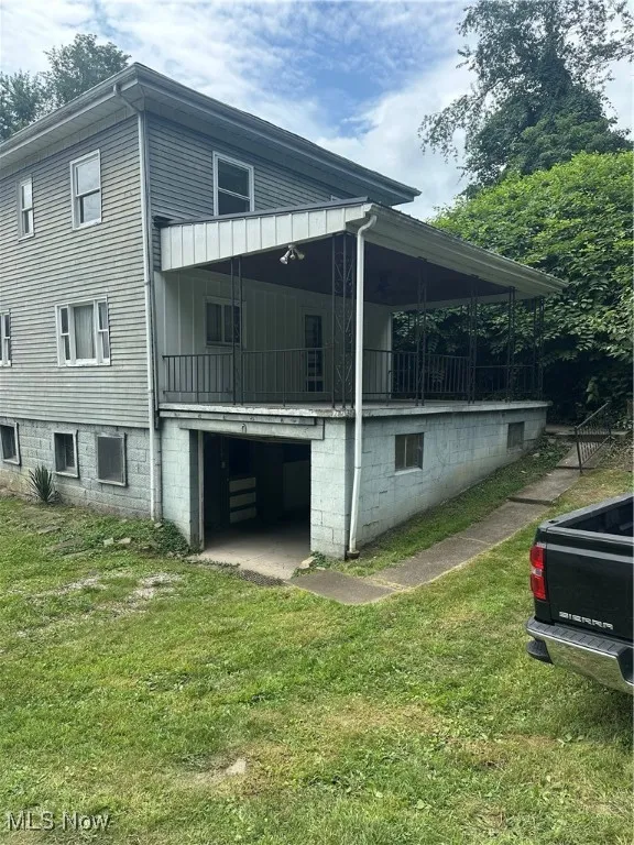 View of home's exterior featuring a yard and an attached garage