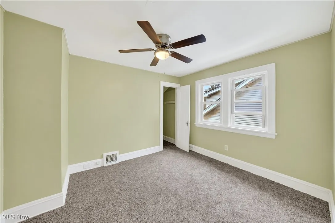 Unfurnished bedroom featuring carpet flooring, a closet, and ceiling fan