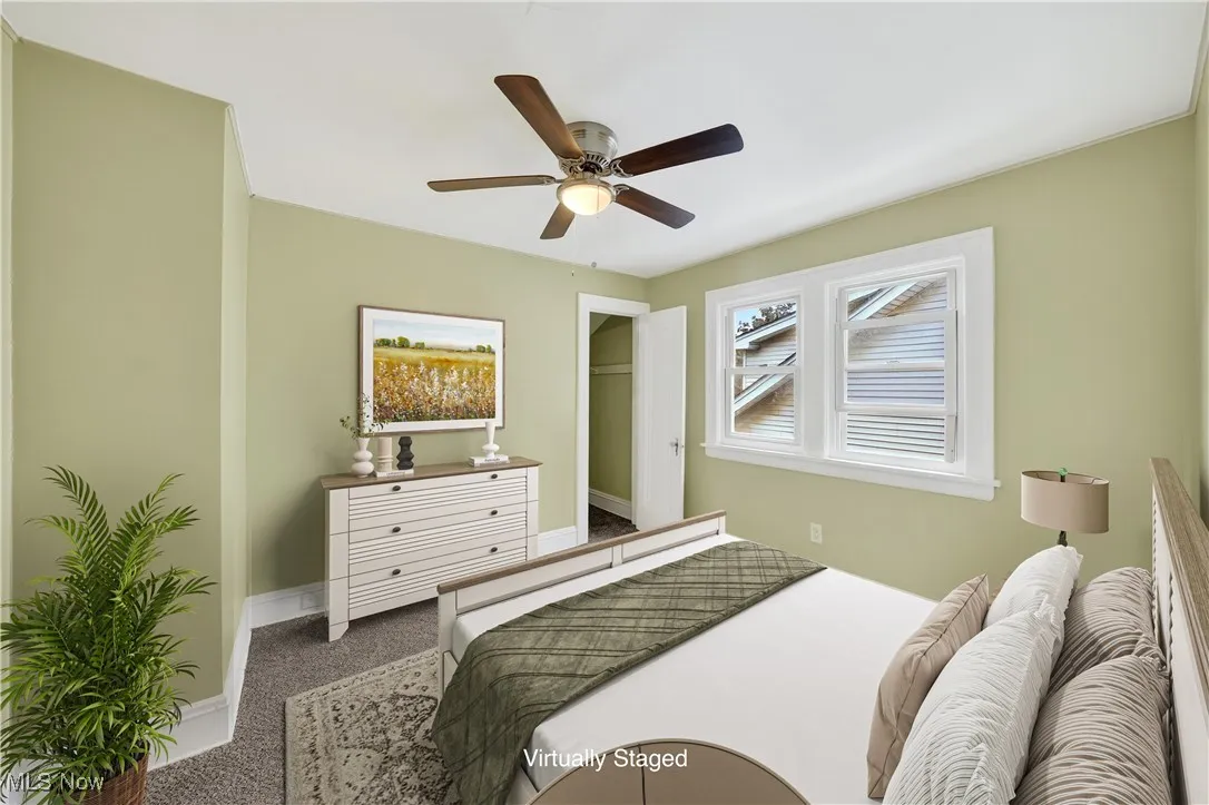 Carpeted bedroom with baseboards and ceiling fan
