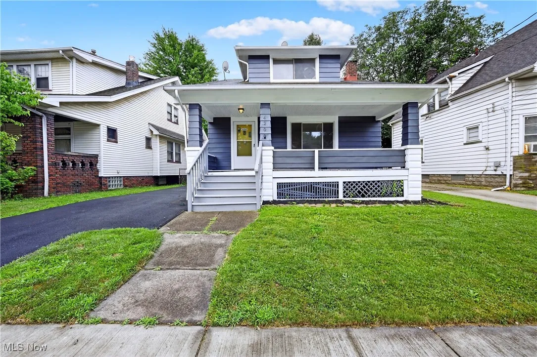View of front of house with a porch and a front yard