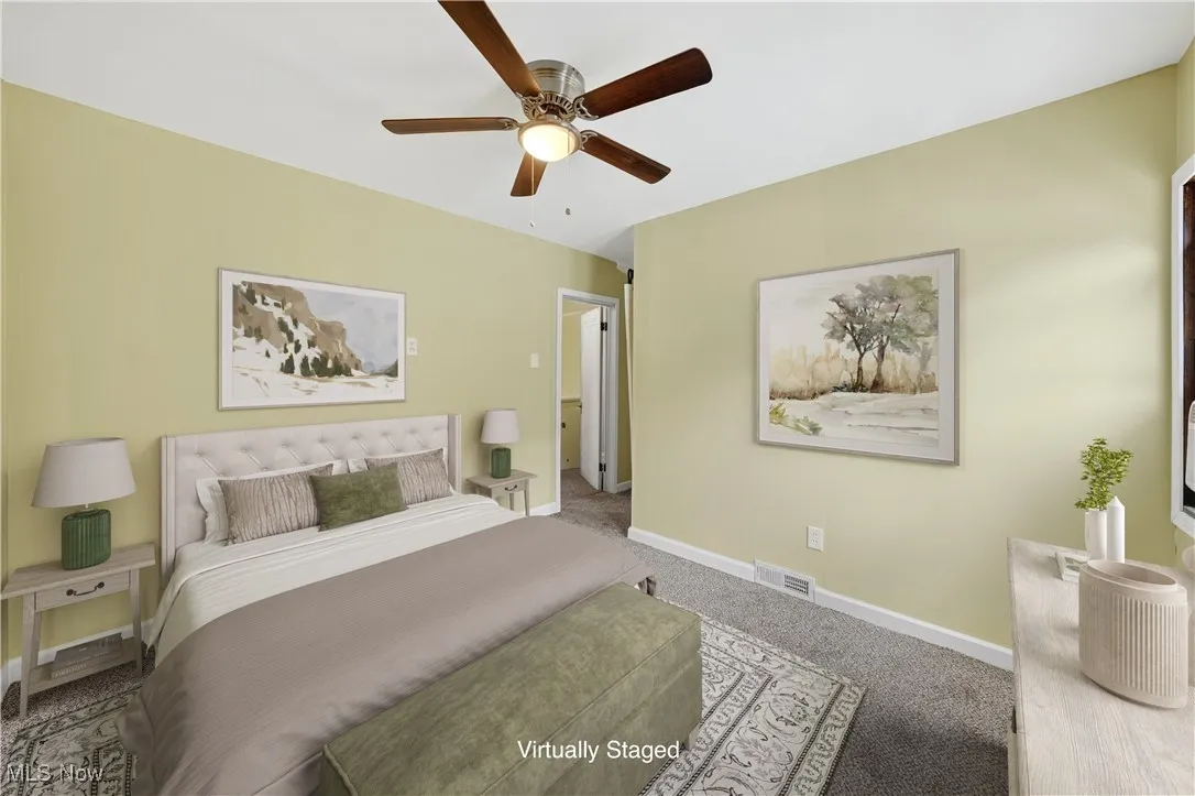 Carpeted bedroom with baseboards and a ceiling fan