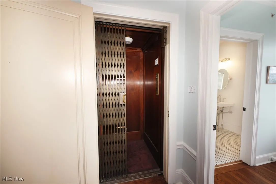 Elevator with wood finished floors and baseboards