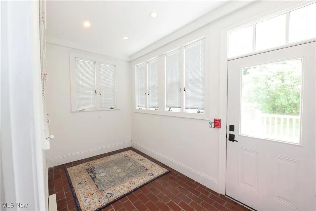 Doorway to outside featuring recessed lighting and brick patterned floors