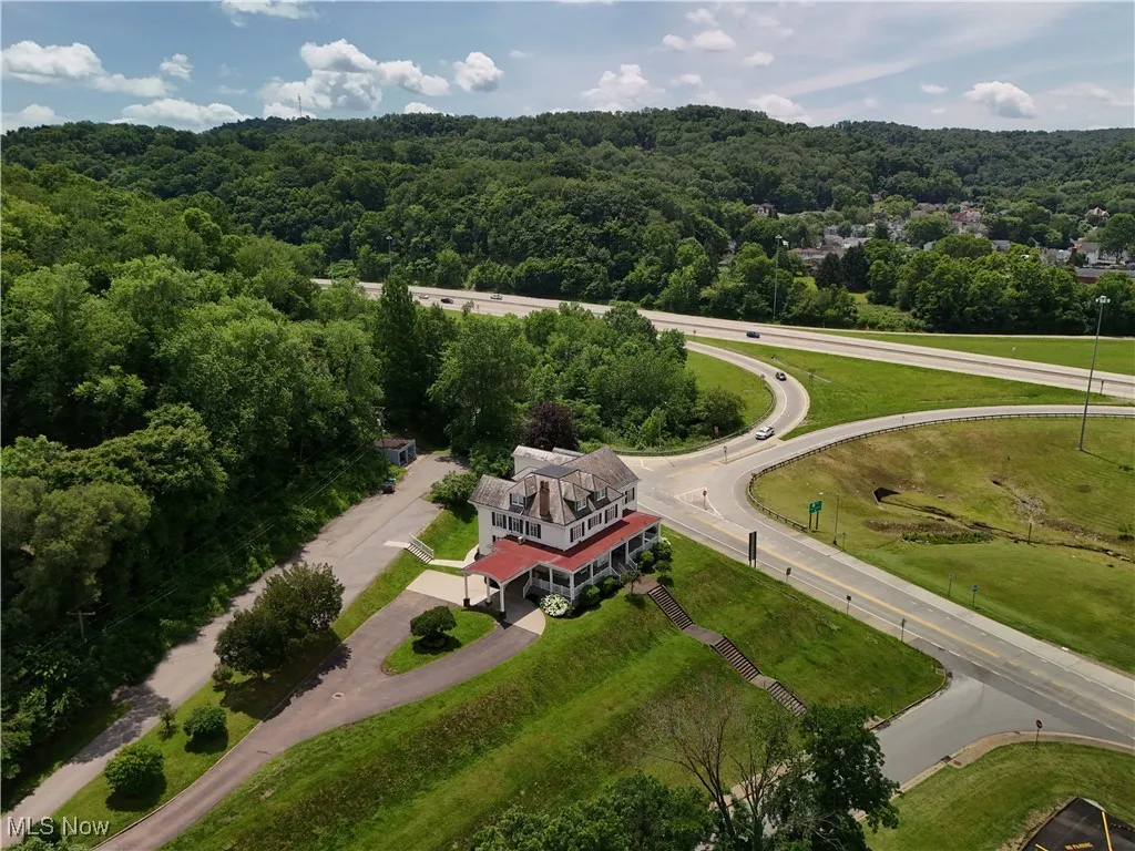 Aerial overview of property's location featuring a heavily wooded area