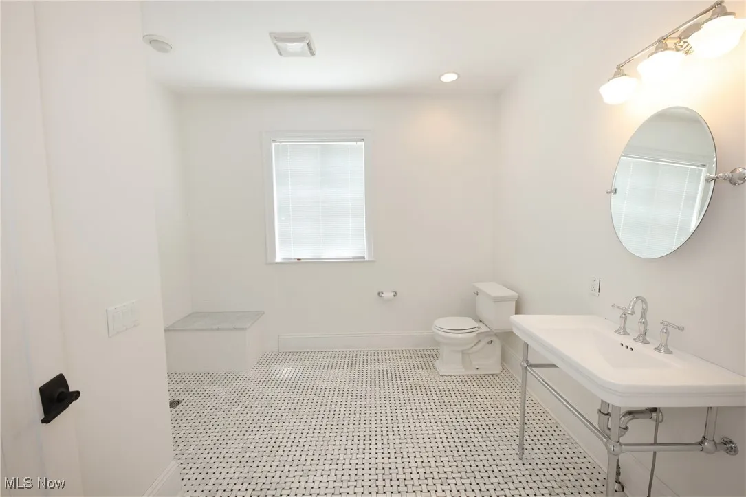 Bathroom featuring a tile shower and tile patterned flooring