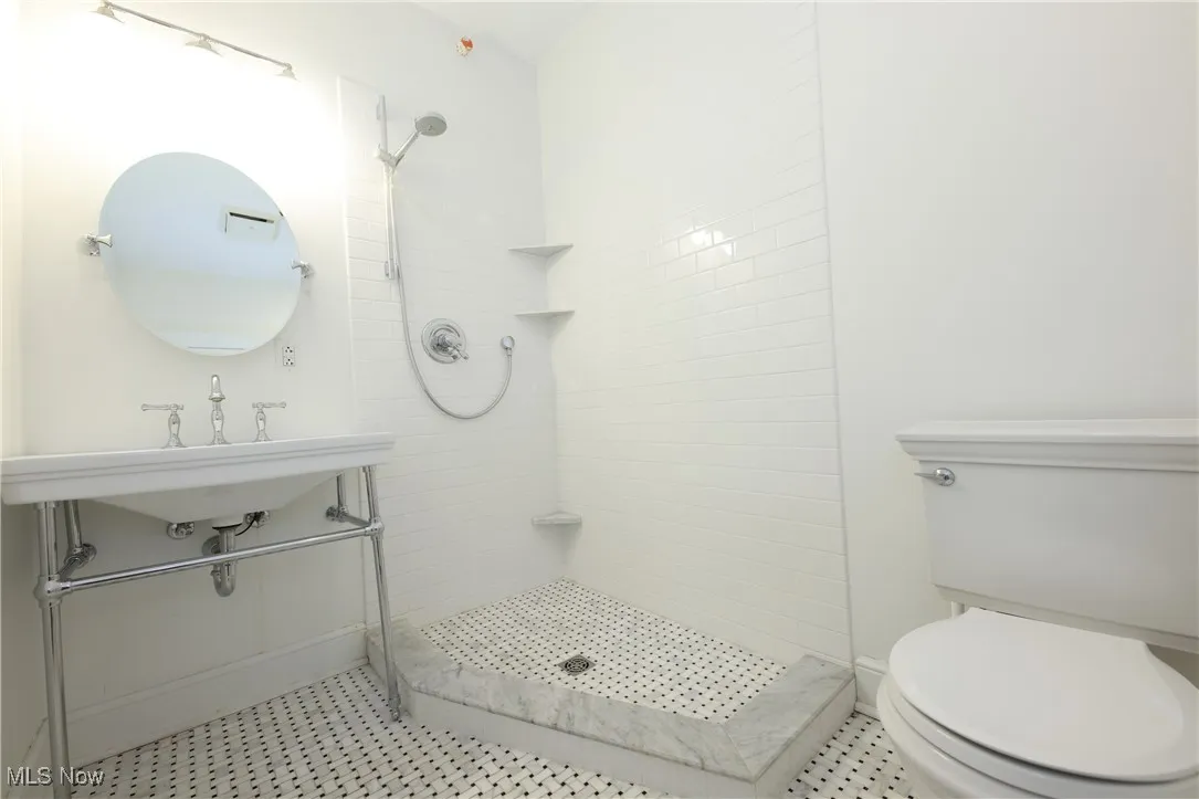 Full bathroom with toilet and tiled shower
