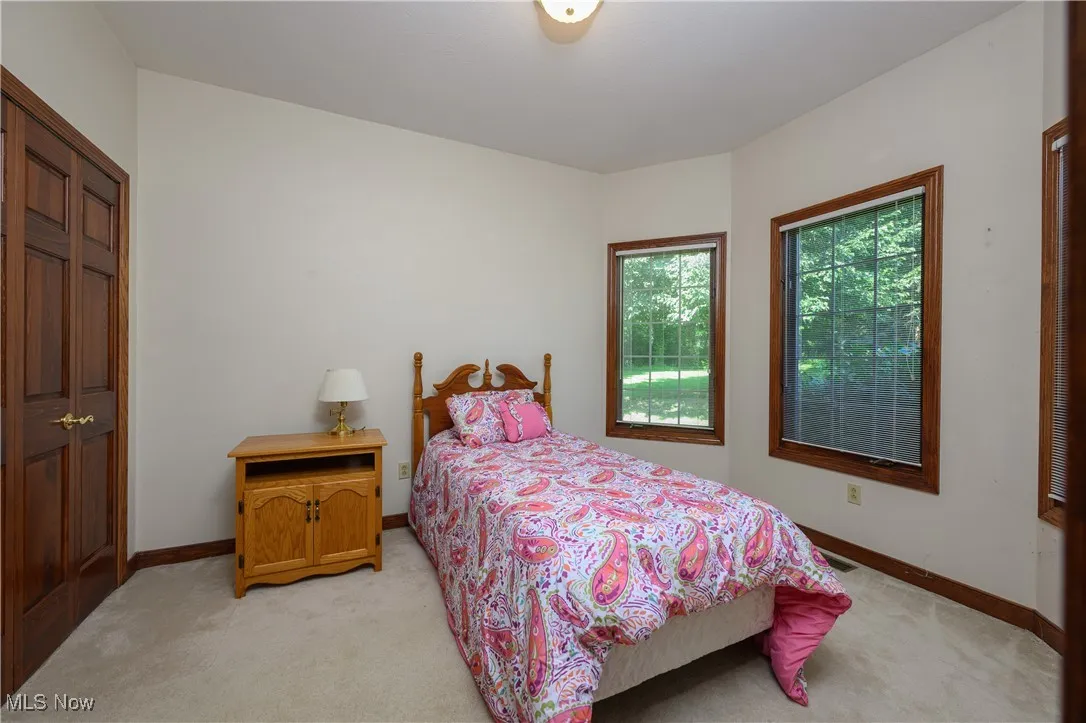 Bedroom featuring light carpet