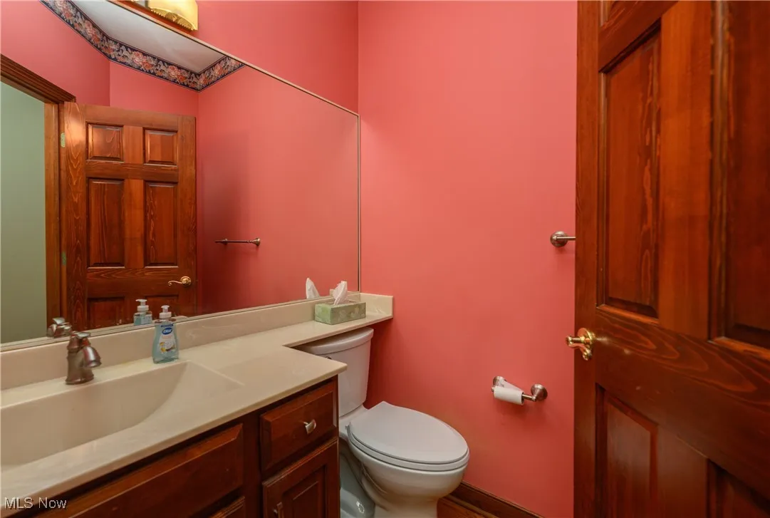 Half bathroom featuring vanity and toilet