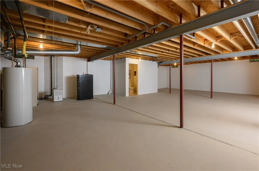 Below grade area featuring water heater