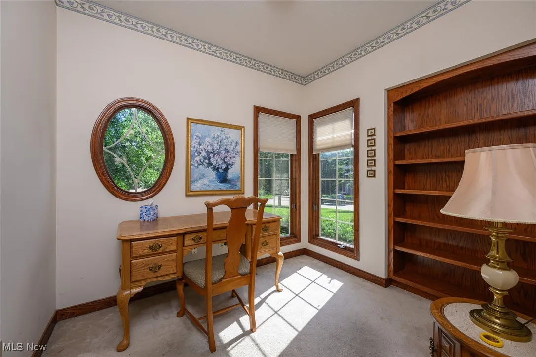 Carpeted office featuring baseboards