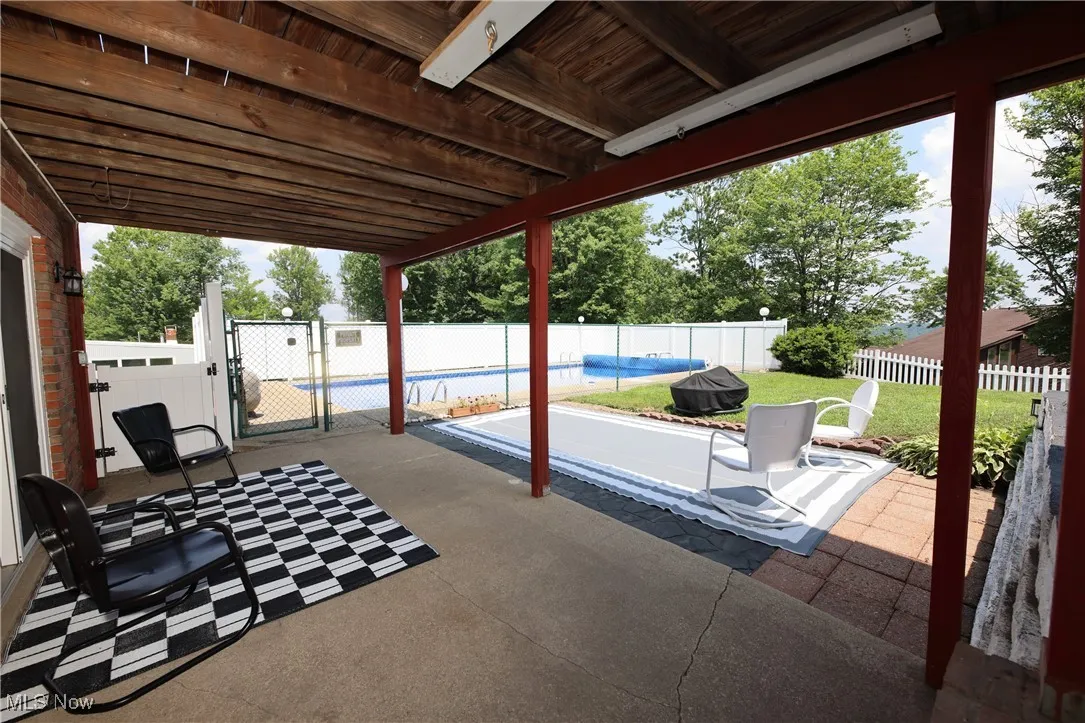 Fenced backyard with a gate and a patio area