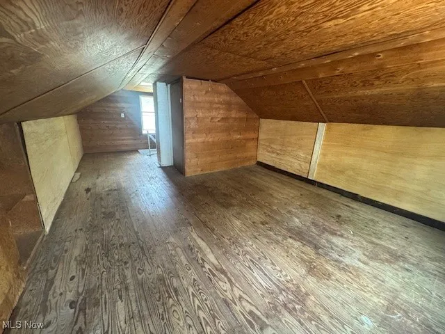 Bonus room with hardwood / wood-style flooring, vaulted ceiling, wooden ceiling, and wooden walls