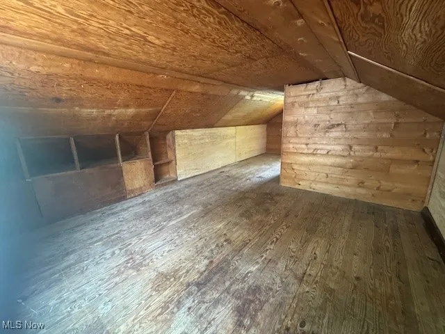 Additional living space with wood-type flooring, vaulted ceiling, and wooden ceiling