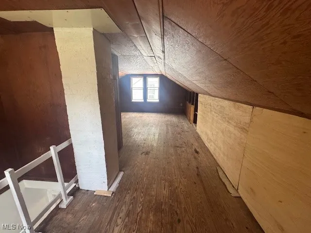 Additional living space featuring hardwood / wood-style floors and vaulted ceiling