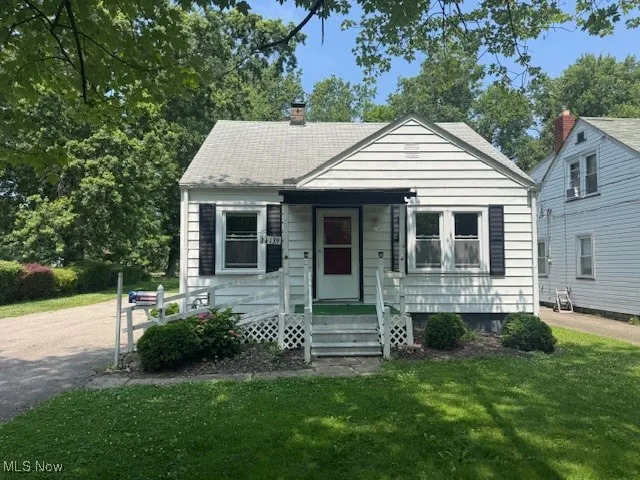 Bungalow with a front yard and a chimney