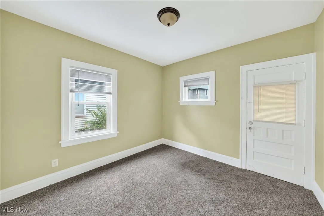 Unfurnished room with dark carpet