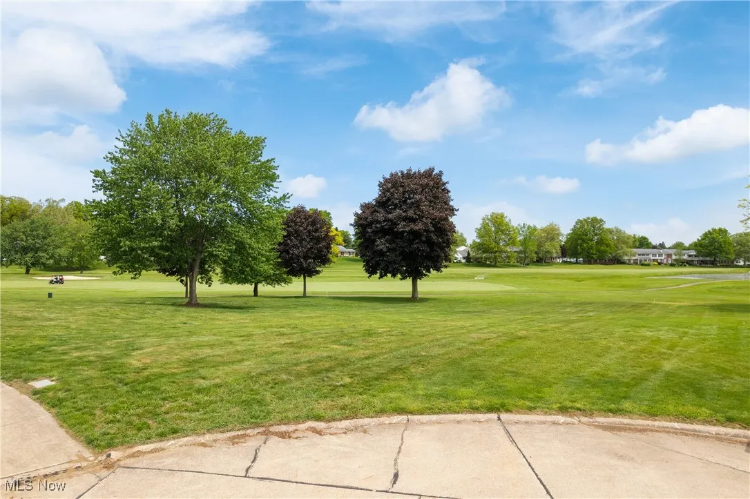 View of lot featuring view of golf course and a lawn