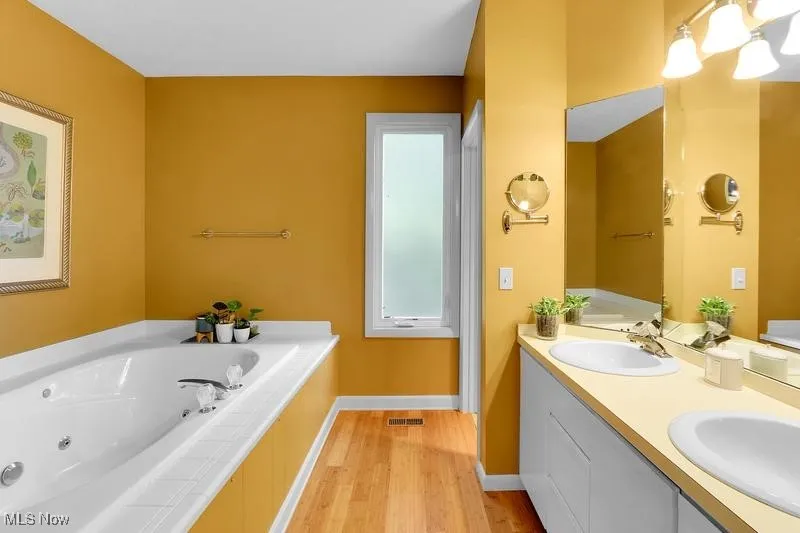 Full bath en suite with jetted tub, dual vanity and separate shower.