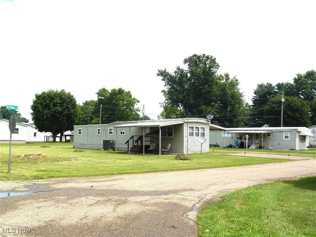 Manufactured / mobile homes with a front lawn, driveway, and an attached carport, corner of Wood and George St.