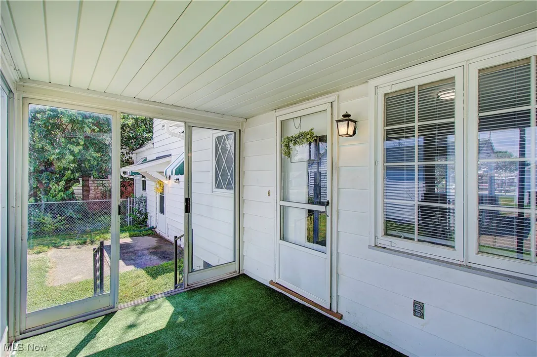 Enclosed patio off the back of the house.  Door leads tot eh dining room.