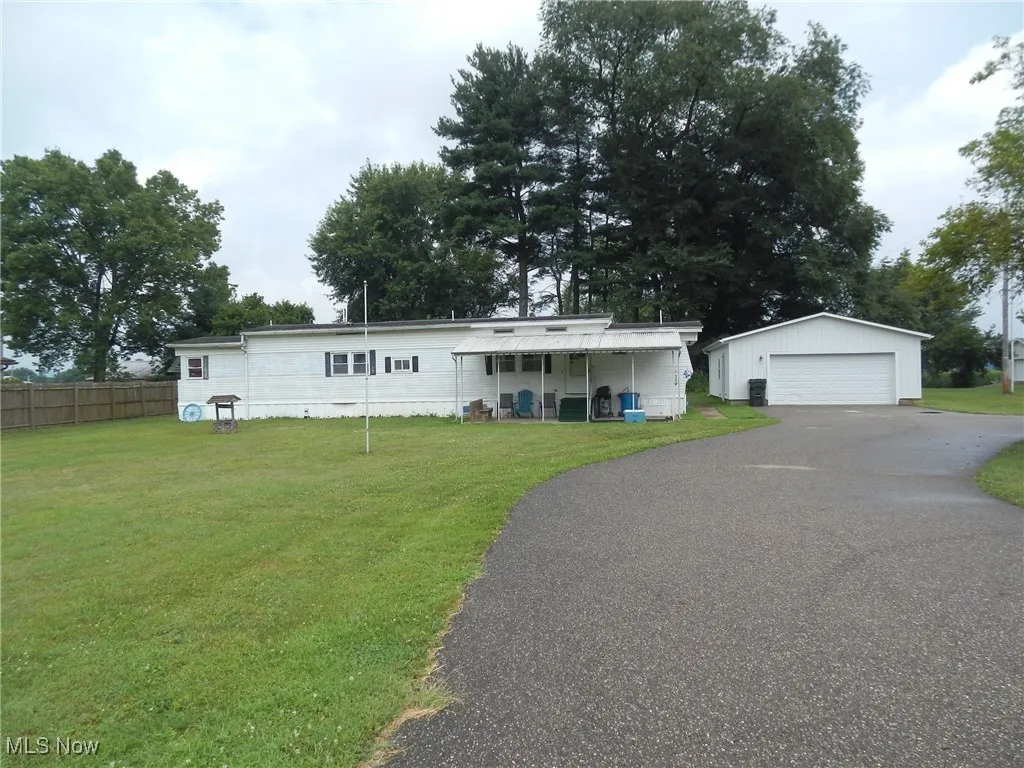 View of front of home featuring an outbuilding and a garage