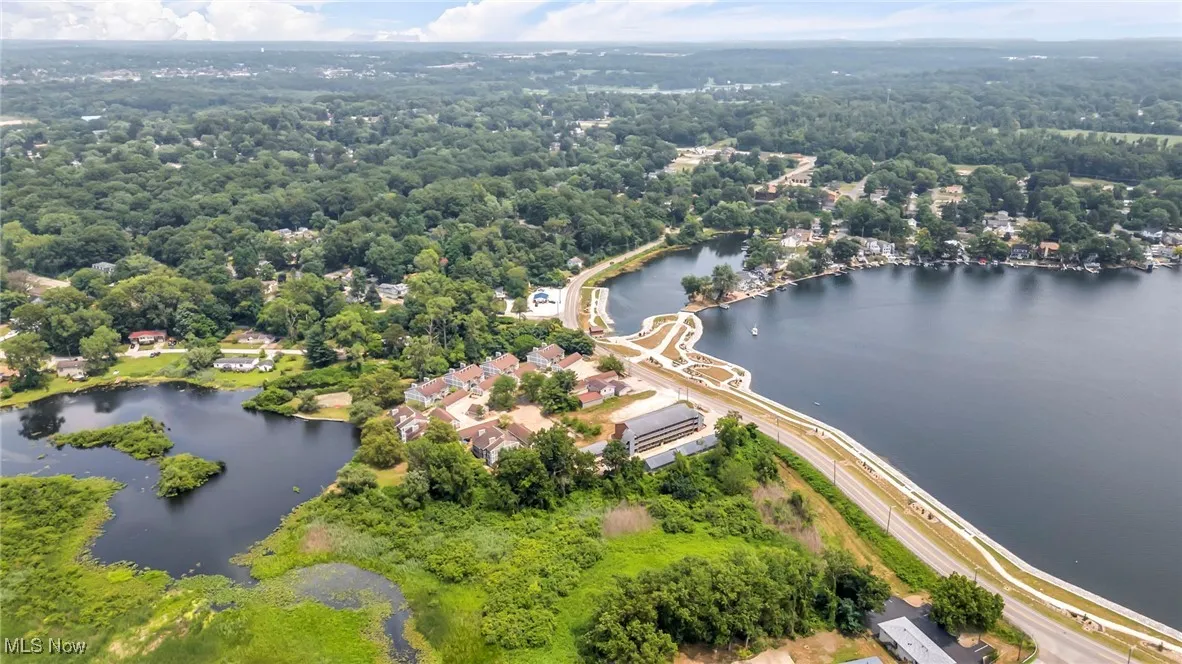 Bird's eye view of a nearby body of water and a heavily wooded area