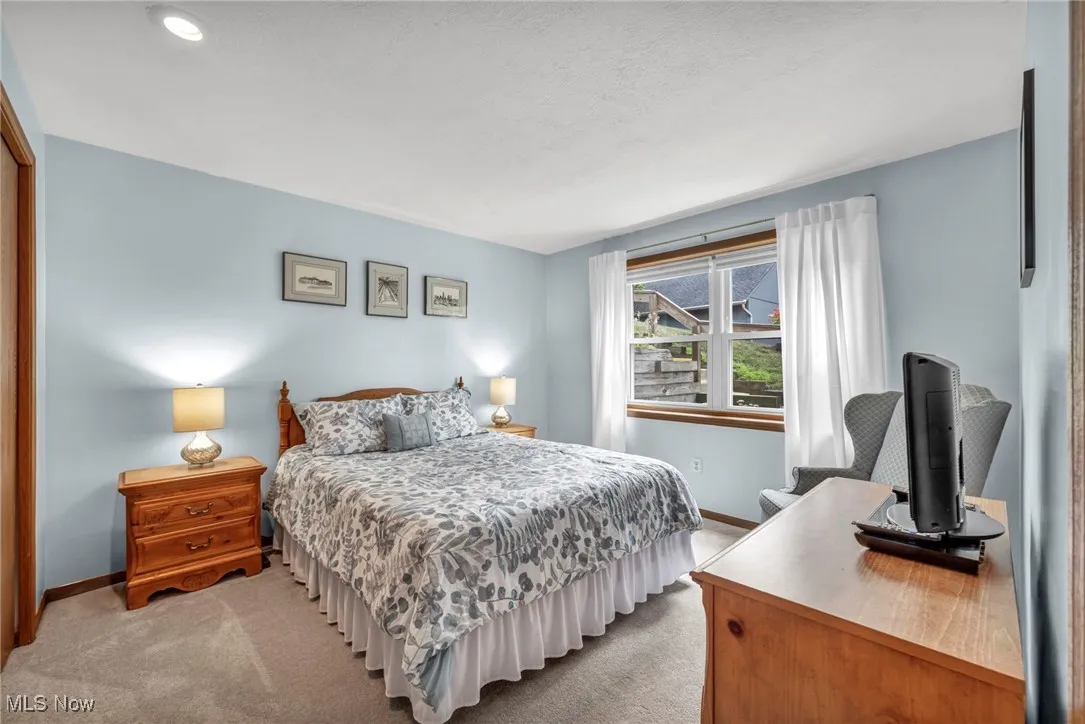 Bedroom with light colored carpet