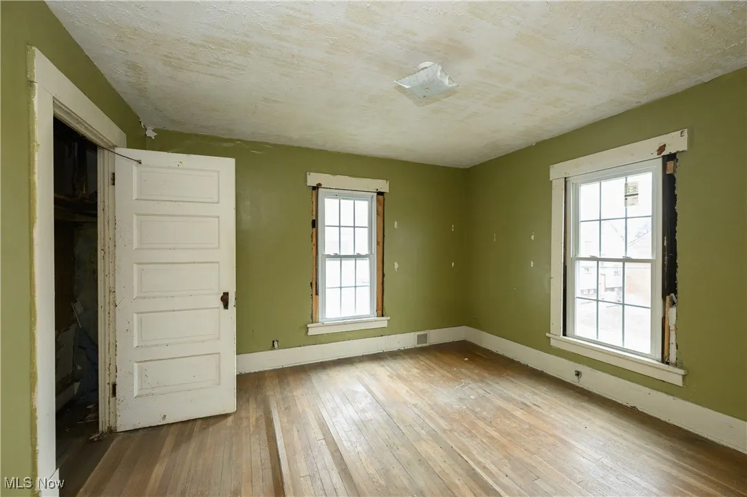 Unfurnished room featuring wood-type flooring and baseboards