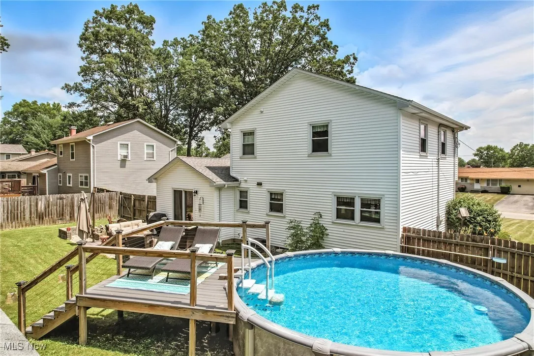 Back of house with a deck and a fenced backyard
