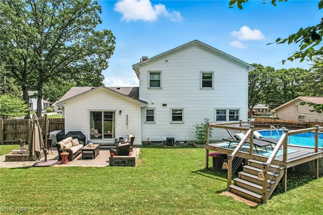 Rear view of property with an outdoor hangout area, a fenced backyard, and a patio area