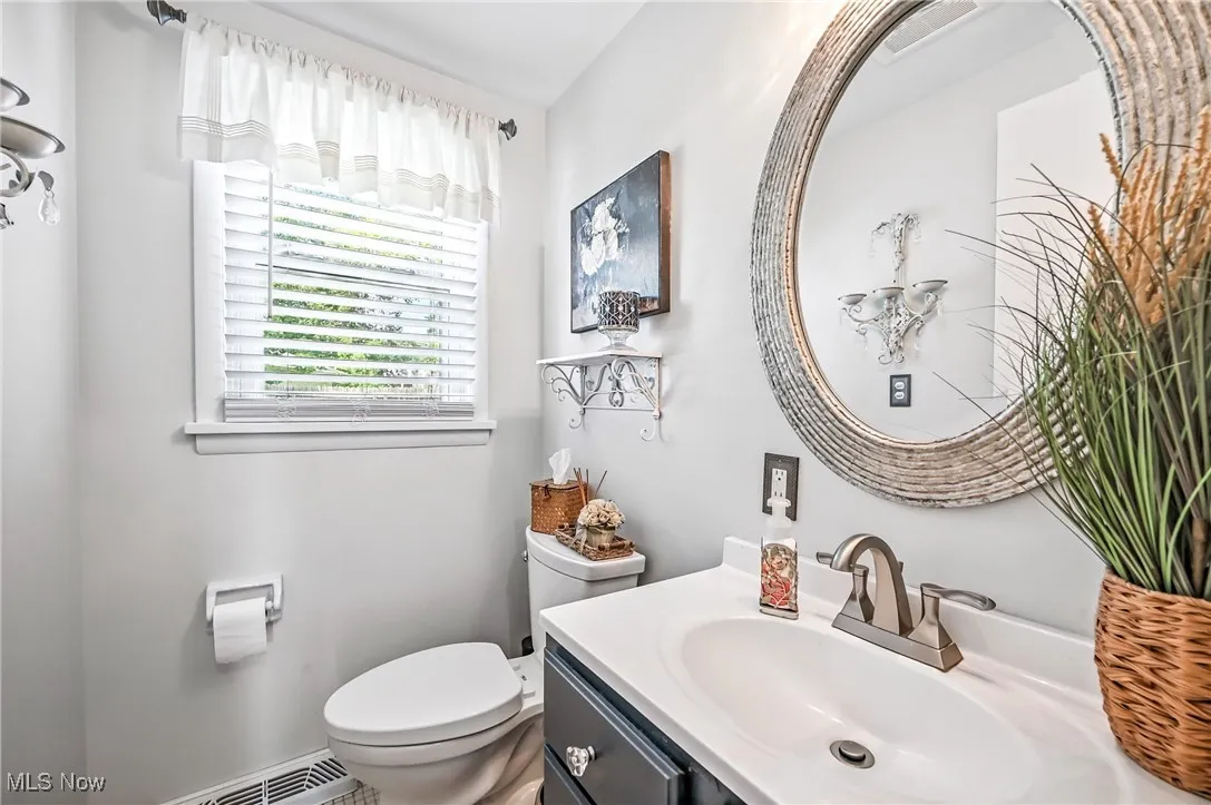 Half bathroom featuring toilet and vanity