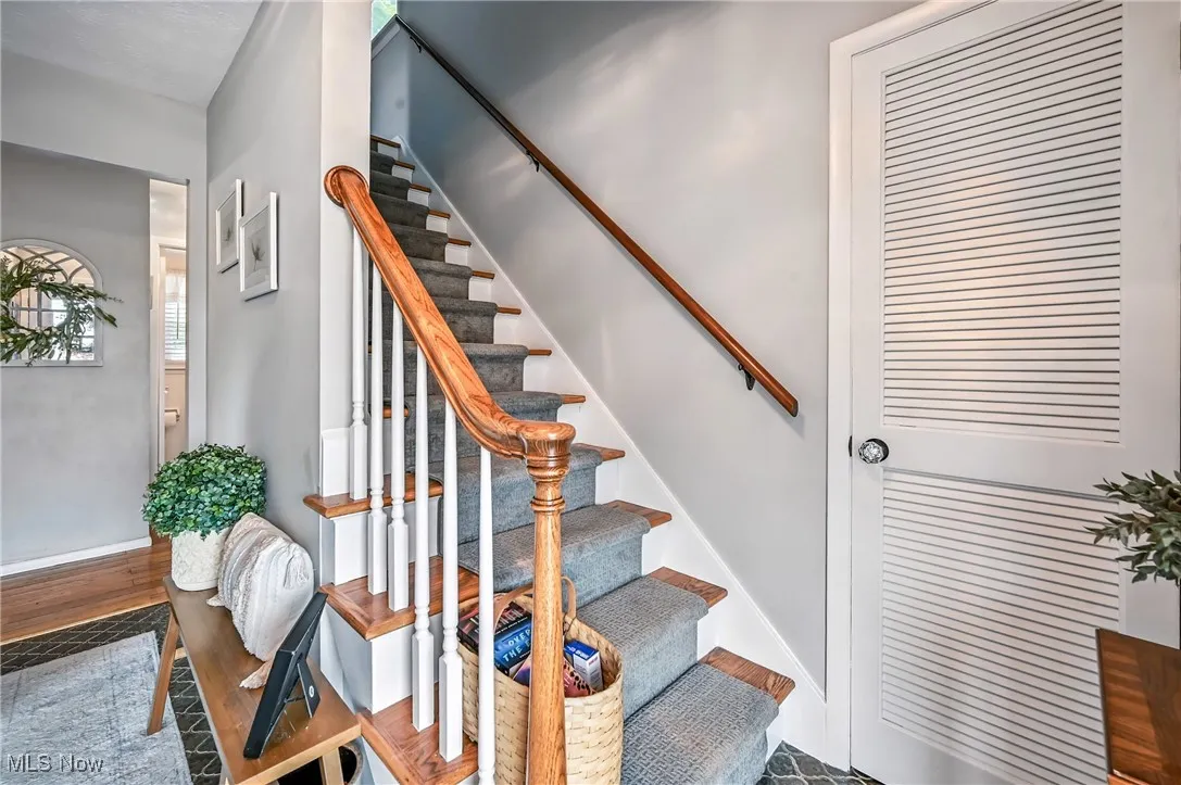 Stairs featuring wood finished floors and baseboards