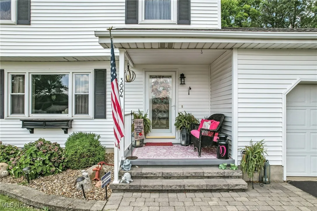 Doorway to property featuring an attached garage