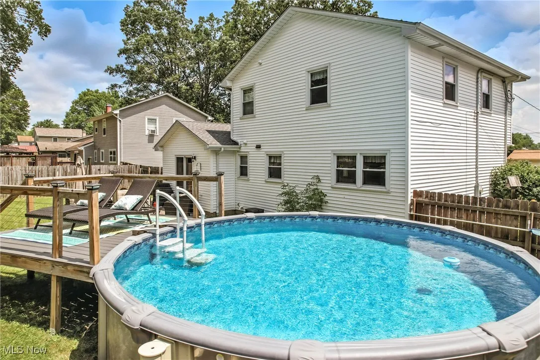 View of pool with a wooden deck