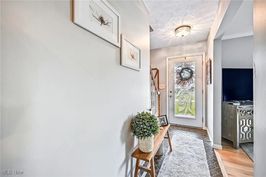 Foyer featuring a textured ceiling and light wood-style floors