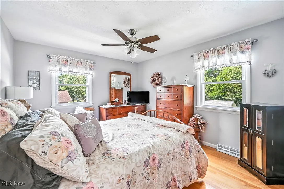 Bedroom with light wood-type flooring and a ceiling fan