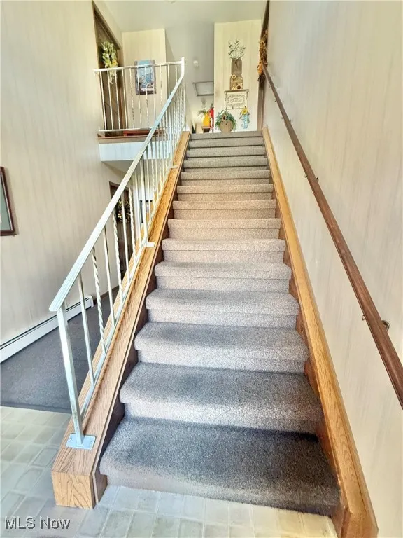 Staircase with a baseboard heating unit