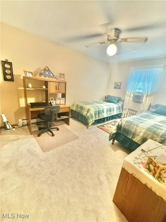 Bedroom featuring carpet, a desk, and a ceiling fan