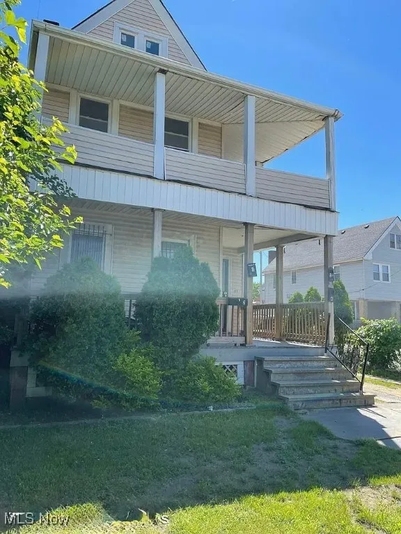 View of front of house featuring a porch and a balcony