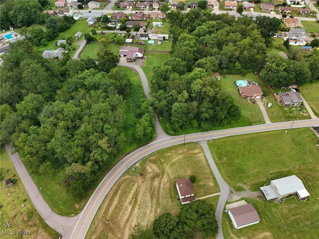 Aerial view of property's location featuring nearby suburban area