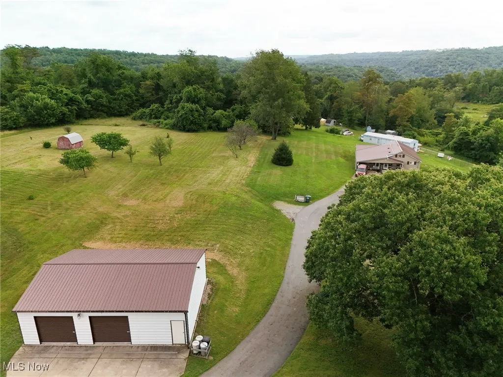 View of subject property with a forest