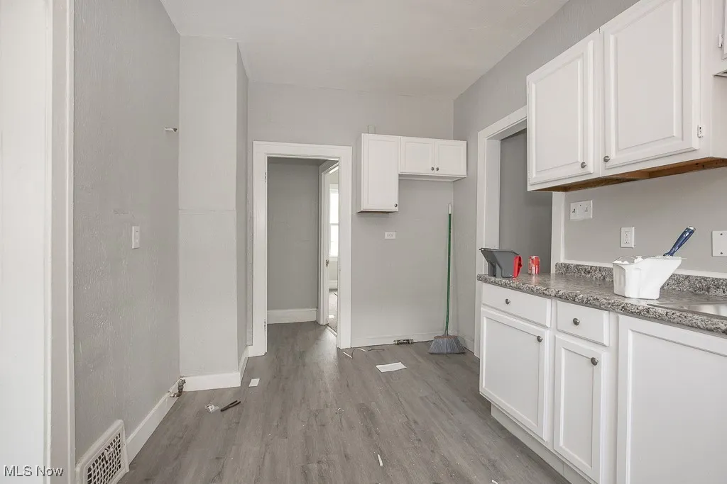 Kitchen featuring white cabinets and light wood finished floors