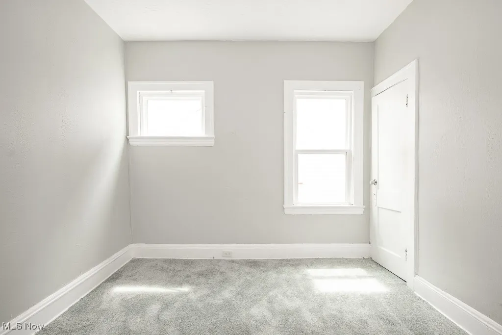 Carpeted spare room with plenty of natural light