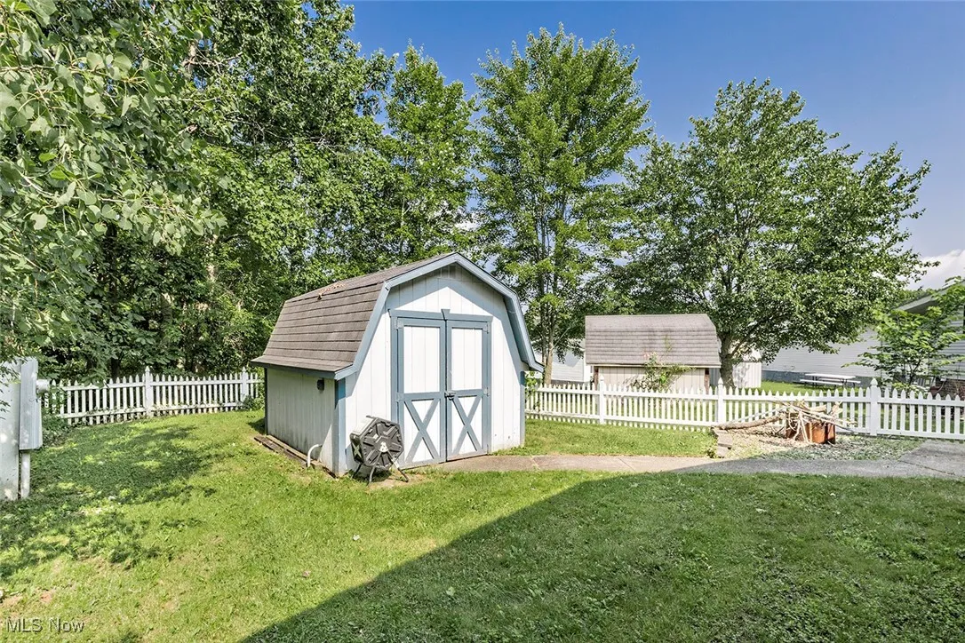 View of shed with a fenced backyard