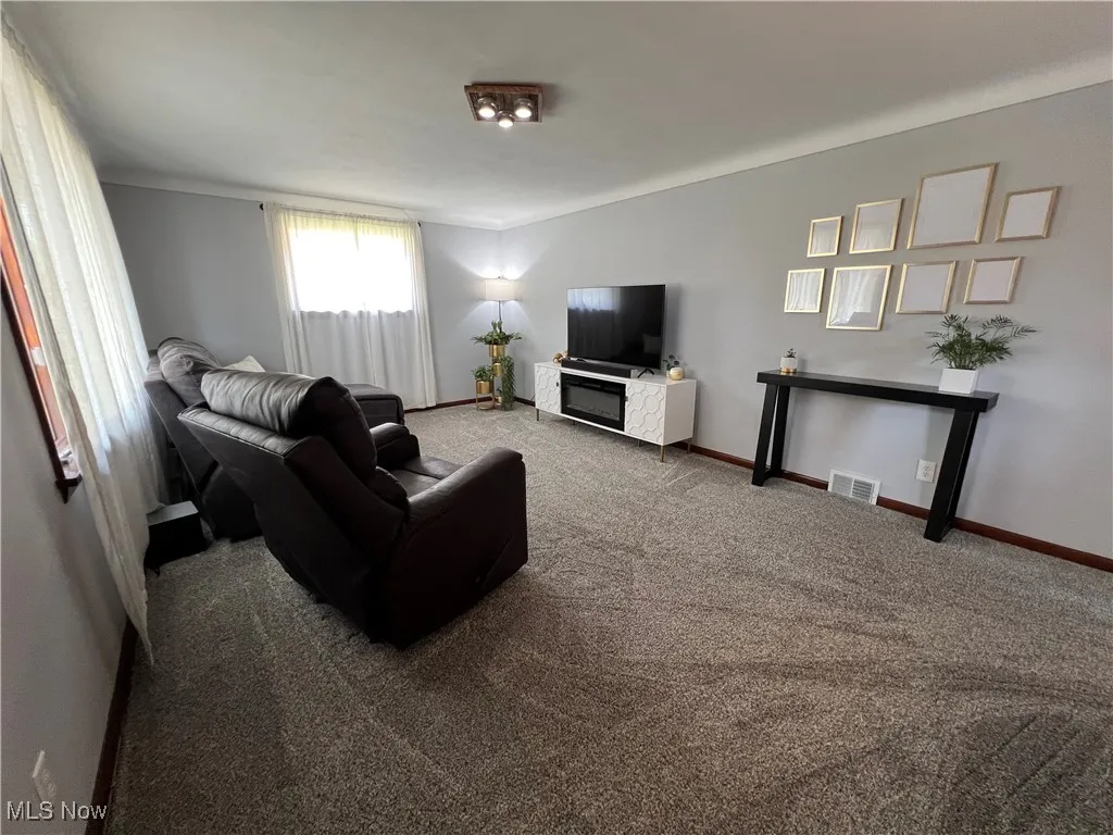 Living room with carpet and baseboards